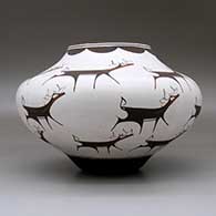 A polychrome jar decorated with a deer-with-heart-line and geometric design, click or tap to see a larger version