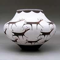 A polychrome jar decorated with a deer-with-heart-line and geometric design, click or tap to see a larger version