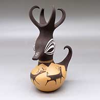 A small polychrome, feather-crested duck pot decorated with a deer-with-heart-line and geometric design
 by Anderson Peynetsa of Zuni