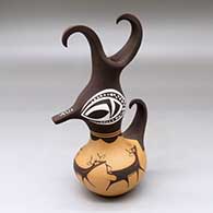 A small polychrome, feather-crested duck pot decorated with a deer-with-heart-line and geometric design
 by Anderson Peynetsa of Zuni