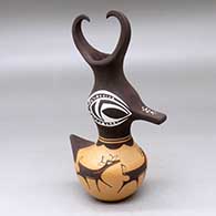 Click for a larger view A small polychrome, feather-crested duck pot decorated with a deer-with-heart-line and geometric design
by Anderson Peynetsa of Zuni