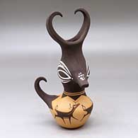 A small polychrome, feather-crested duck pot decorated with a deer-with-heart-line and geometric design
 by Anderson Peynetsa of Zuni