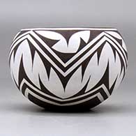 A small polychrome bowl decorated around the body with a geometric design, click or tap to see a larger version