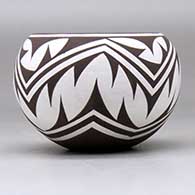 A small polychrome bowl decorated around the body with a geometric design, click or tap to see a larger version