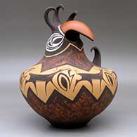A crested parrot jar decorated with a deer with heart line and geometric design, click or tap to see a larger version