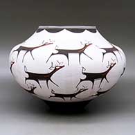 A polychrome jar decorated with a deer-with-heart-line and geometric design, click or tap to see a larger version