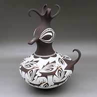 A polychrome duck pot decorated around the body with a deer with heart line and geometric design
 by Anderson Peynetsa of Zuni