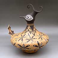 A polychrome duck pot decorated around the body with a dragonfly and geometric design
 by Anderson Jamie Peynetsa of Zuni