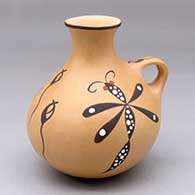 A polychrome jar with a handle, a short flaring neck and decorated with a dragonfly and tadpole design
 by Anderson Jamie Peynetsa of Zuni