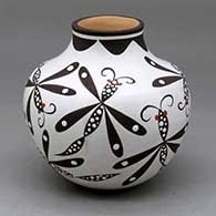 A polychrome jar with a short neck and decorated with a dragonfly and geometric design
 by Anderson Jamie Peynetsa of Zuni