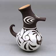 A small polychrome duck pot decorated with a rainbird, dragonfly and geometric design
 by Anderson Jamie Peynetsa of Zuni