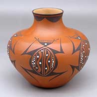 A polychrome jar with a short flaring neck and decorated with a five panel frog katsina and geometric design
 by Anderson Jamie Peynetsa of Zuni