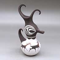 A polychrome duck figure with a feathered crown and decorated with a deer-with-heart-line and geometric design
 by Anderson Peynetsa of Zuni