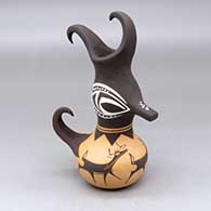 A small duck effigy pot with a feathered crown and decorated with a deer with heart line and geometric design
 by Anderson Peynetsa of Zuni
