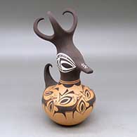 A polychrome duck pot decorated around the body with a deer with heart line, mountains, forest and geometric design
 by Anderson Peynetsa of Zuni