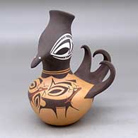 A polychrome turkey pot decorated around the body with a deer with heart line, mountains, forest and geometric design
 by Anderson Peynetsa of Zuni