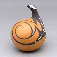 A polychrome seed pot decorated with a lizard head applique and lizard and geometric design
 by Anderson Peynetsa of Zuni