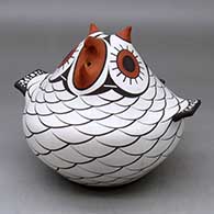 A polychrome owl figure decorated with a bird element and geometric design
 by Anderson Jamie Peynetsa of Zuni
